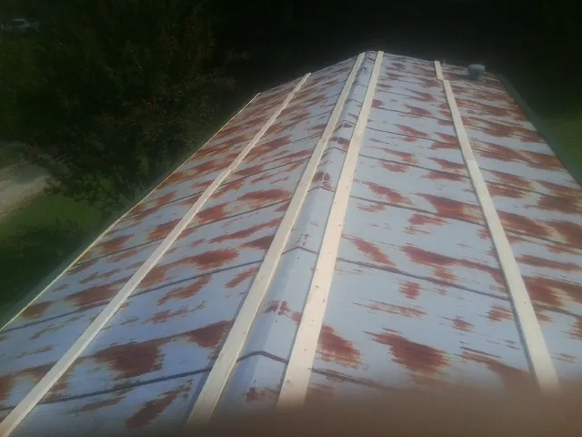 Rusted metal roof panels with new wood purlins before replacement — Storm Damage Roof Repair in West Hills by Roofing Brothers