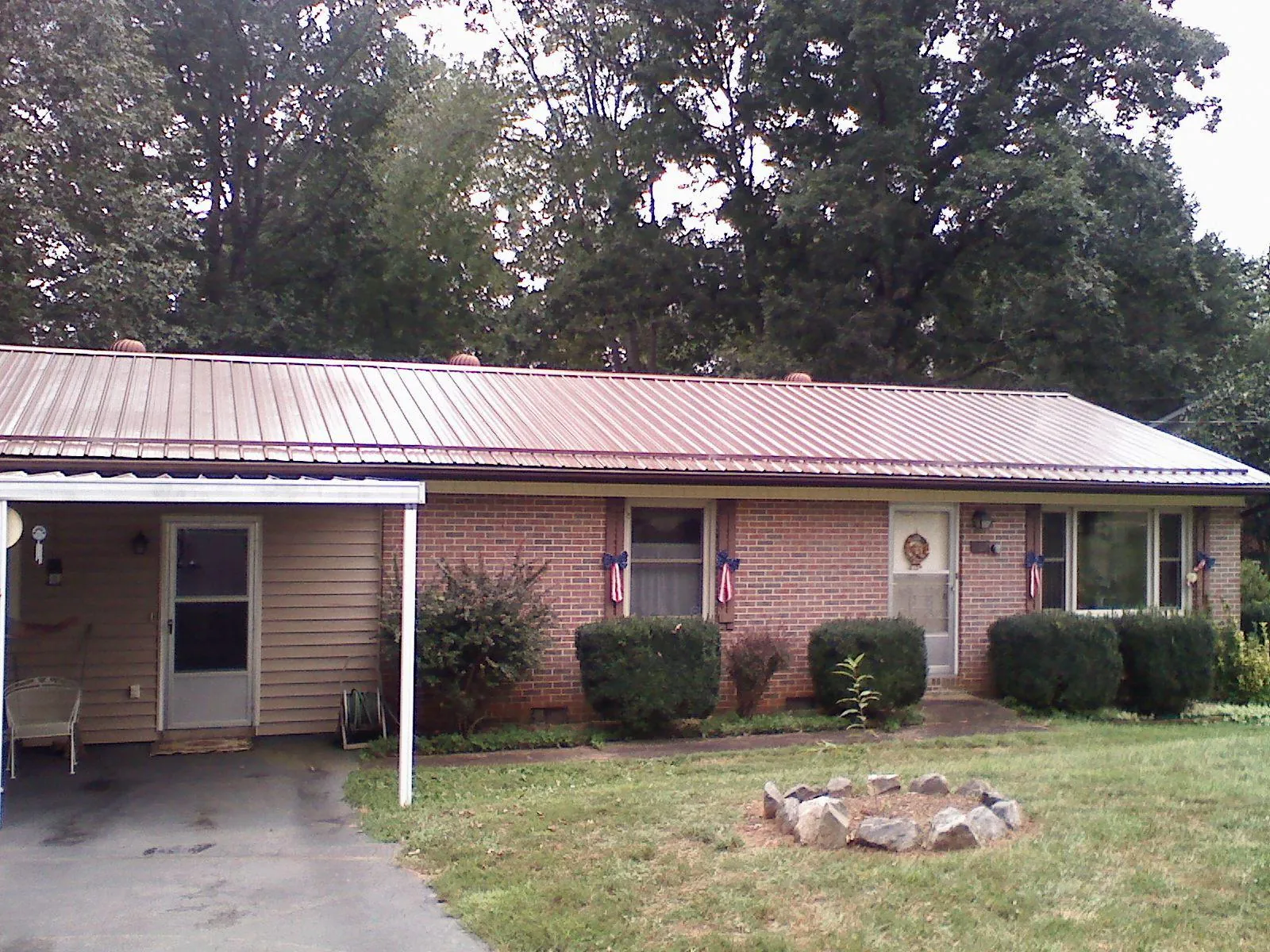 Bronze metal roof and carport on a brick ranch home — Roof Repair work by our crew in West Hills