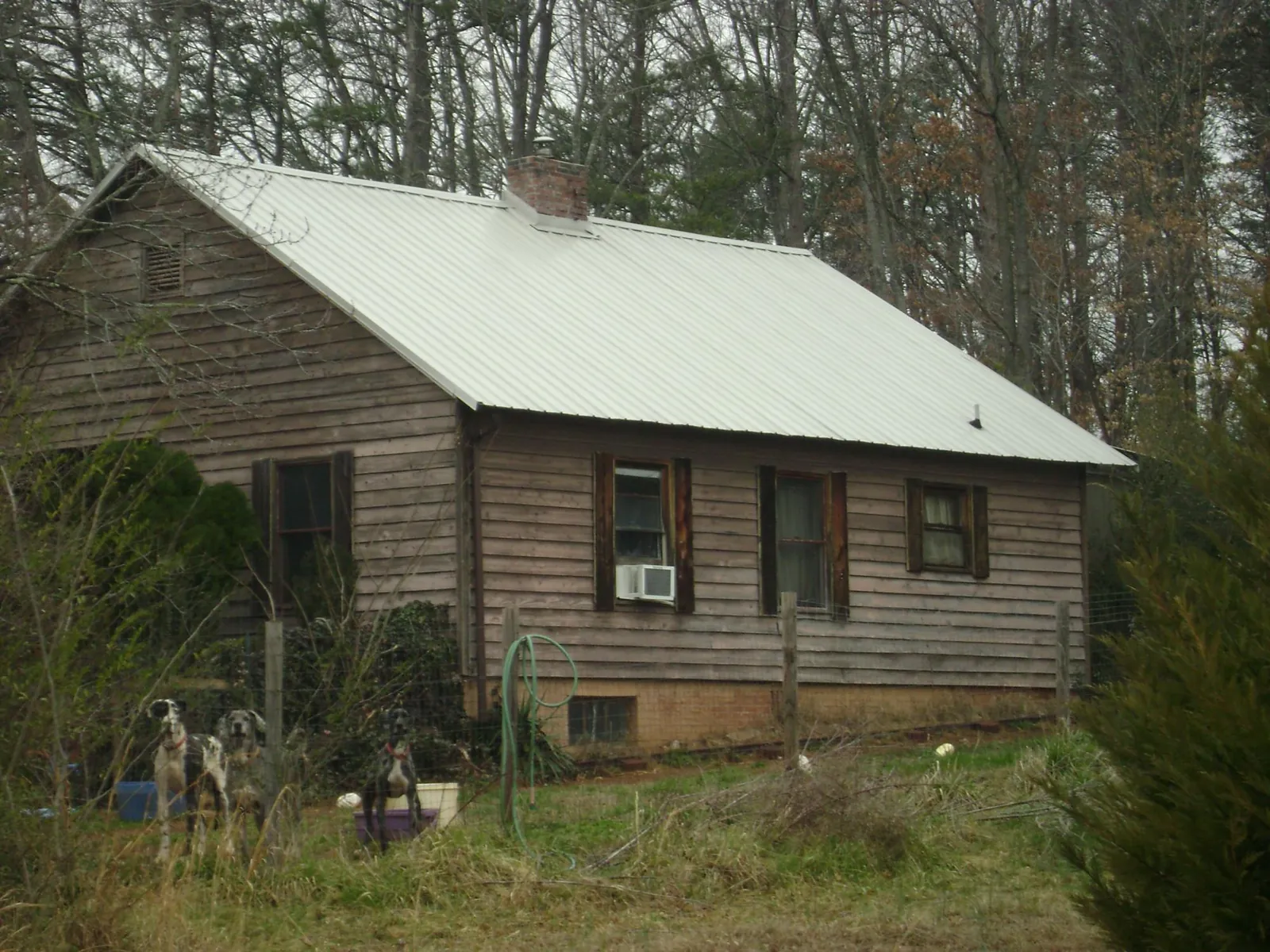 White metal roof on an old wood sided farmhouse, from a Metal Roof Installation job in West Hills
